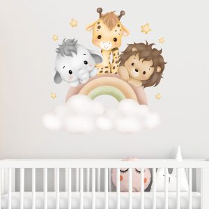 Adesivi da muro per cameretta bambini con animali e arcobaleno sopra un lettino.