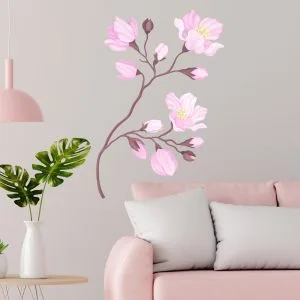 Adesivo da parete ramo fiorito decorativo applicato accanto a poltrona rosa