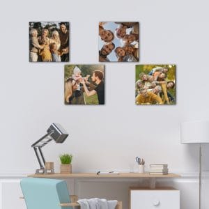 Quadretti personalizzati con foto su tela disposti sopra una scrivania moderna con foto di famiglia stampate su tela.